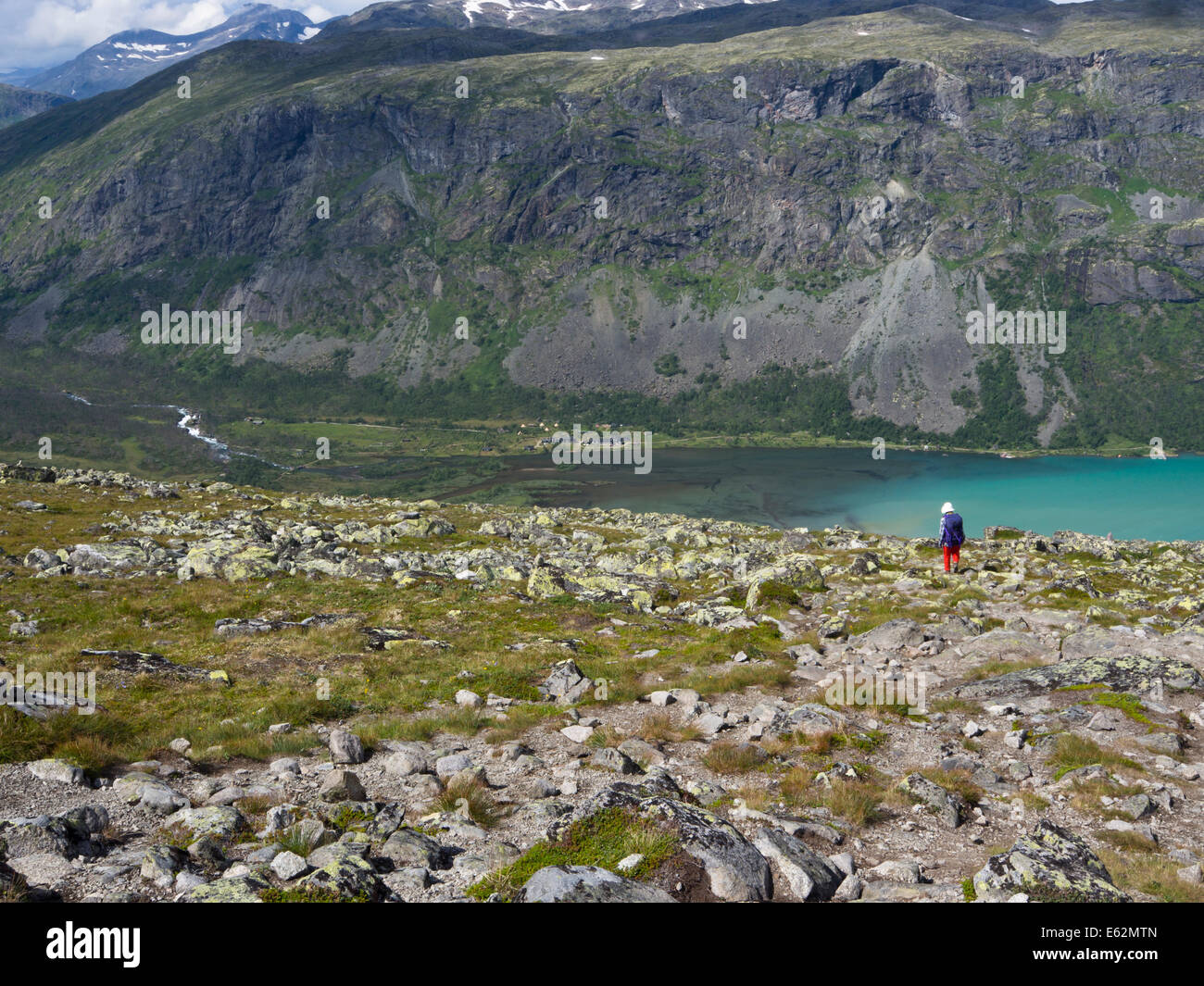 Le parc national de Jotunheimen Norvège,female hiker regardant vers le bas au lac Gjende et Svartdalen Gjendebu lodge de mountain pass Banque D'Images