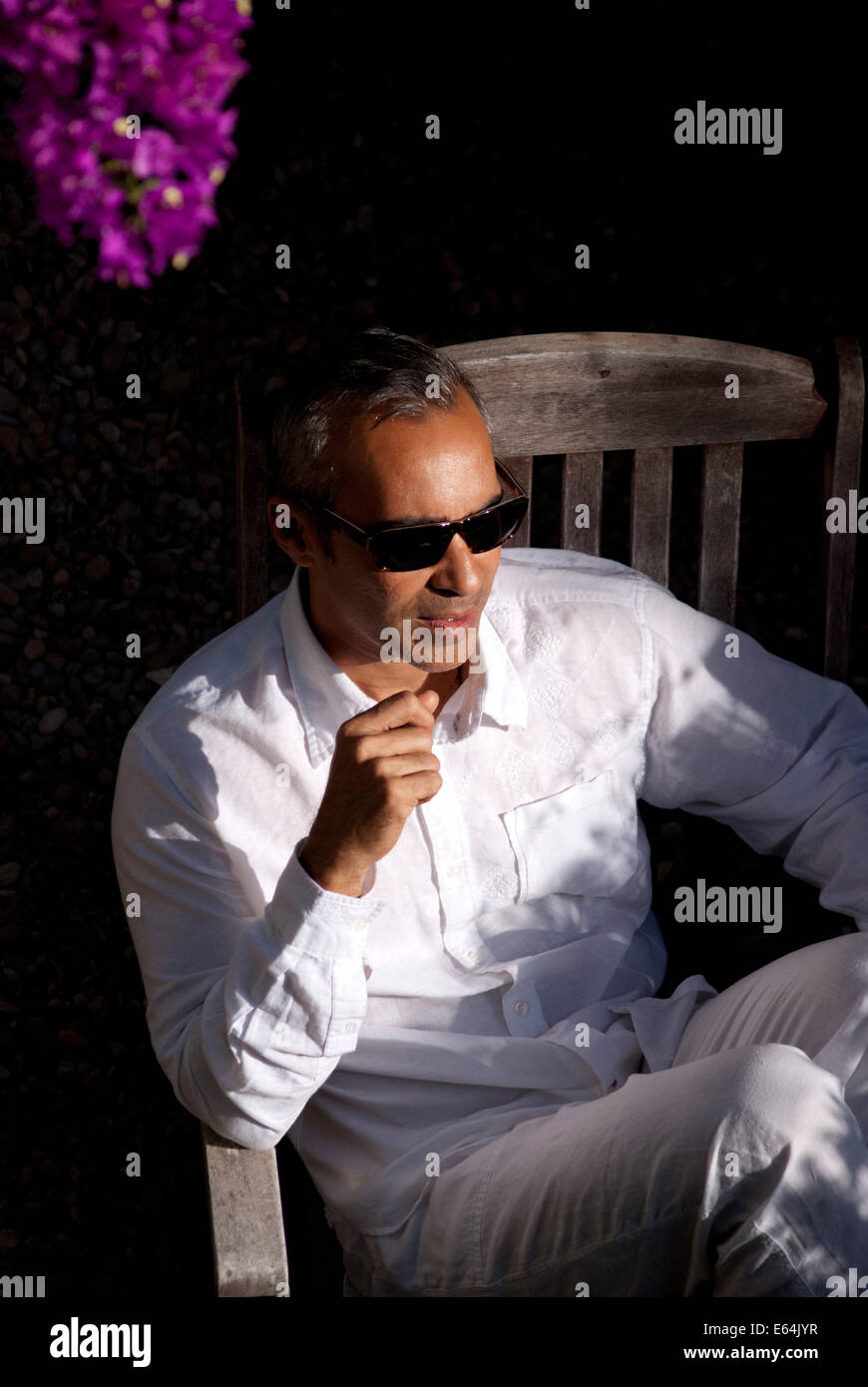 Homme mûr assis dans le jardin Banque D'Images