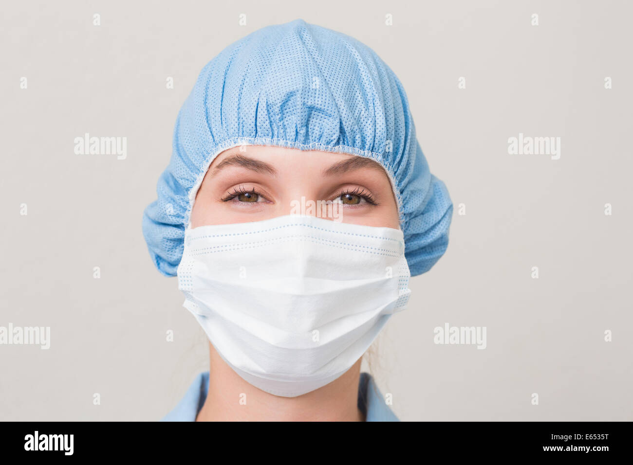 Dentiste en masque chirurgical et cap looking at camera Banque D'Images