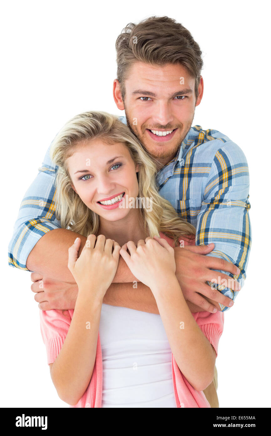 Attractive young couple smiling at camera Banque D'Images