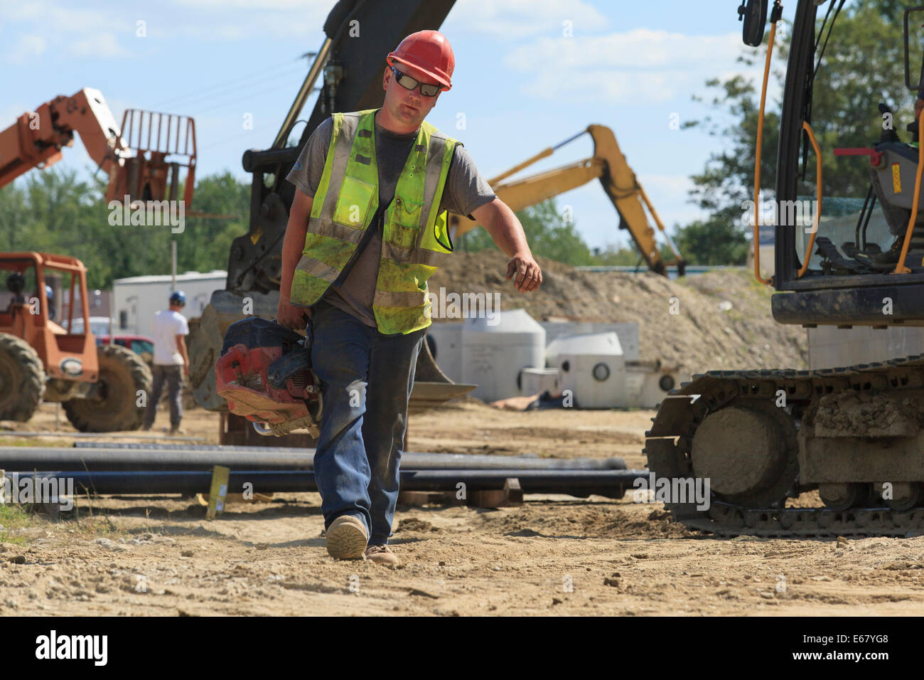 Ingénieur de construction de coupe de tuyaux transportant des grumes au site de construction lourde pelle avec Banque D'Images