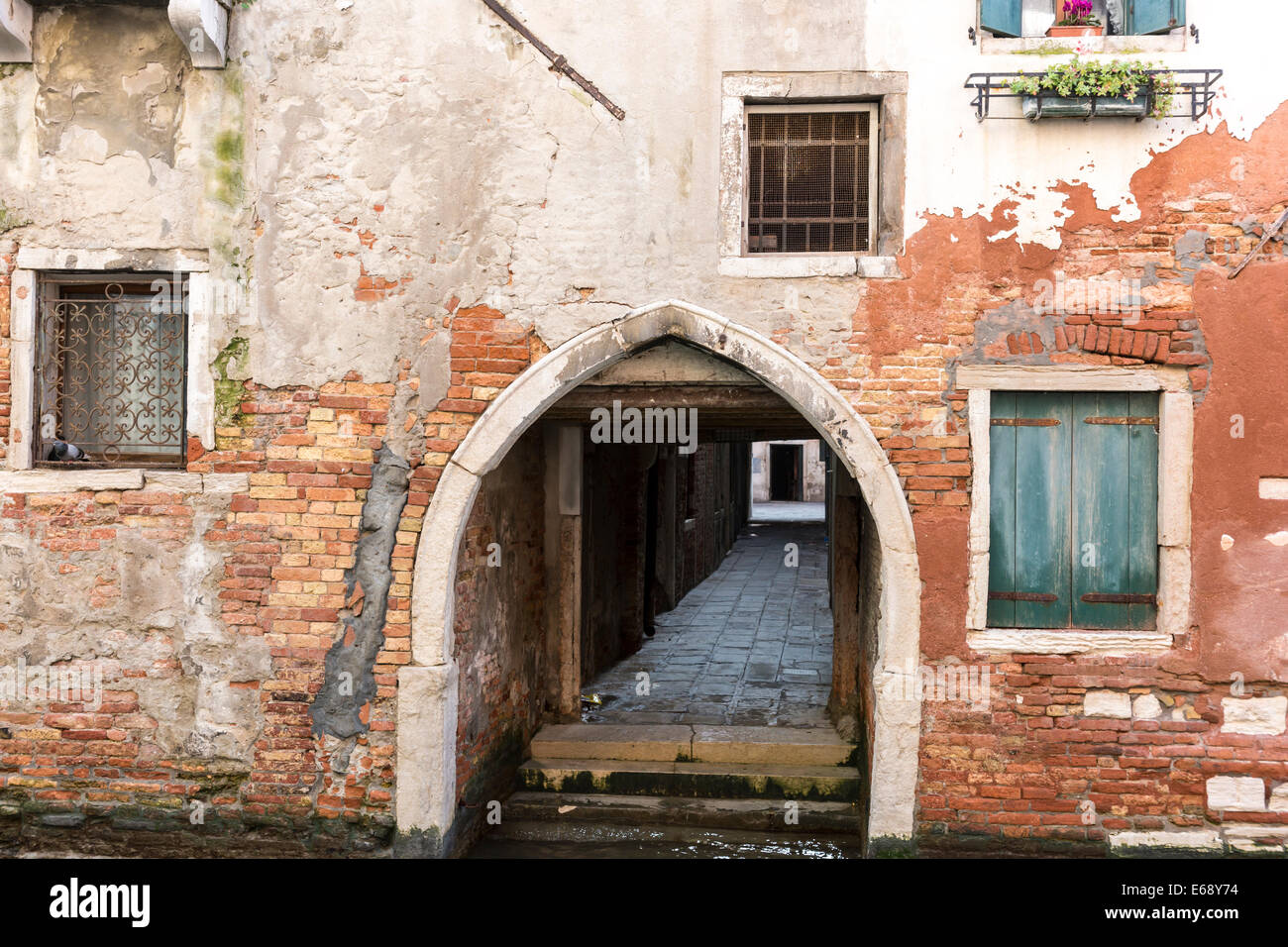 L'édicule voûté terrain adjacent, fenêtres donnant sur un canal latéral à Venise. Banque D'Images