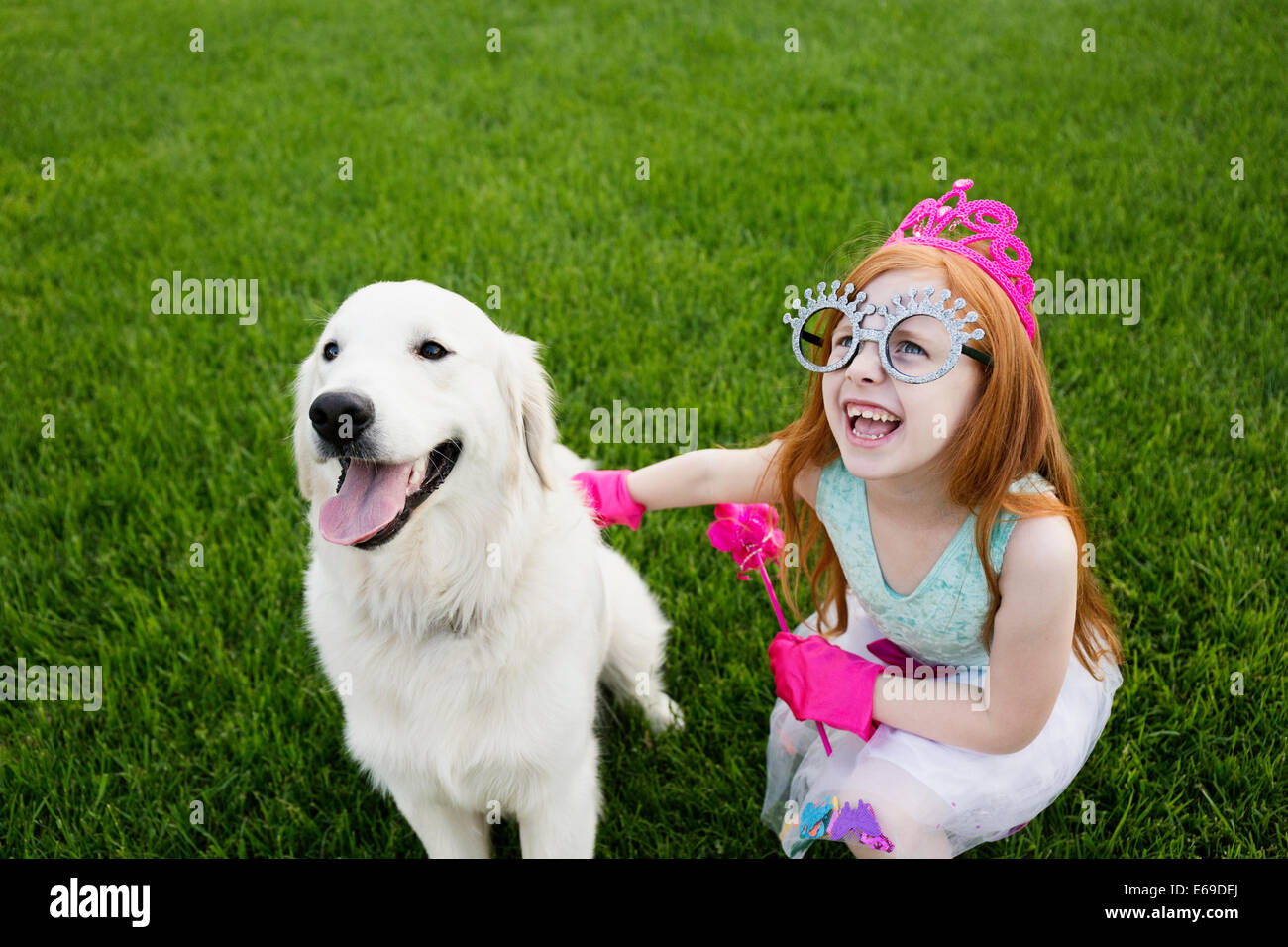 Caucasian girl playing dress up in park Banque D'Images
