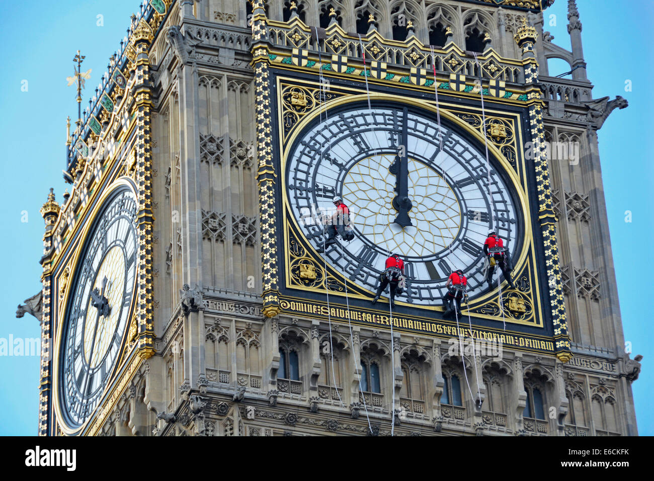 Hommes au travail descendant en rappel sur des cordes Big Ben Elizabeth Tower visage de l'horloge en cours de nettoyage avec les mains mises à la mauvaise heure de midi Westminster Londres Angleterre Royaume-Uni Banque D'Images