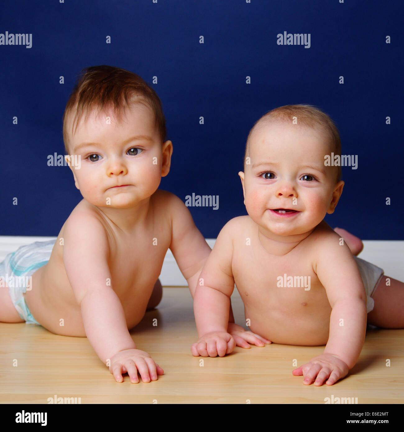 Frère jumeau bébé garçon tenant leurs têtes vers le haut Banque D'Images