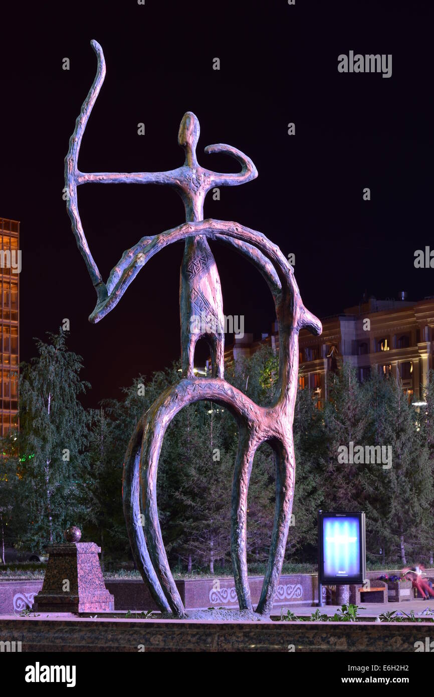 Une vue de la nuit d'une statue de bronze en pseudo-style primitif doté d''un rider sur l'arrière de tir à l'arc Banque D'Images