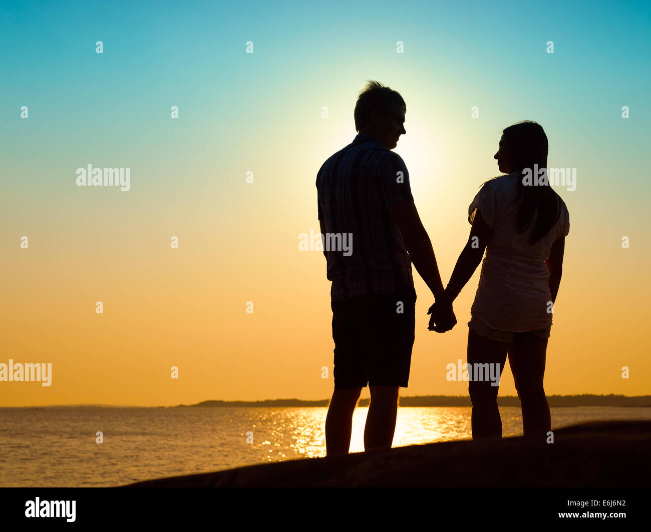 Jeune couple dans l'amour pour le coucher du soleil ensemble, belle soirée à archipelago Banque D'Images