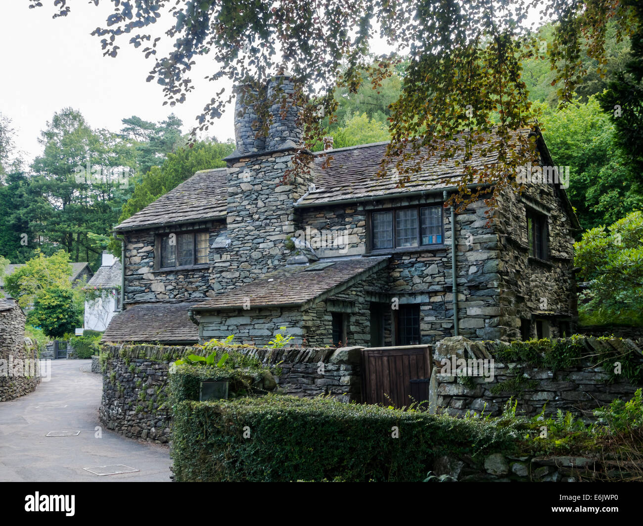 Un cottage en pierre sur un chemin de campagne dans le village de Grasmere dans le Lake District, Cumbria England Banque D'Images