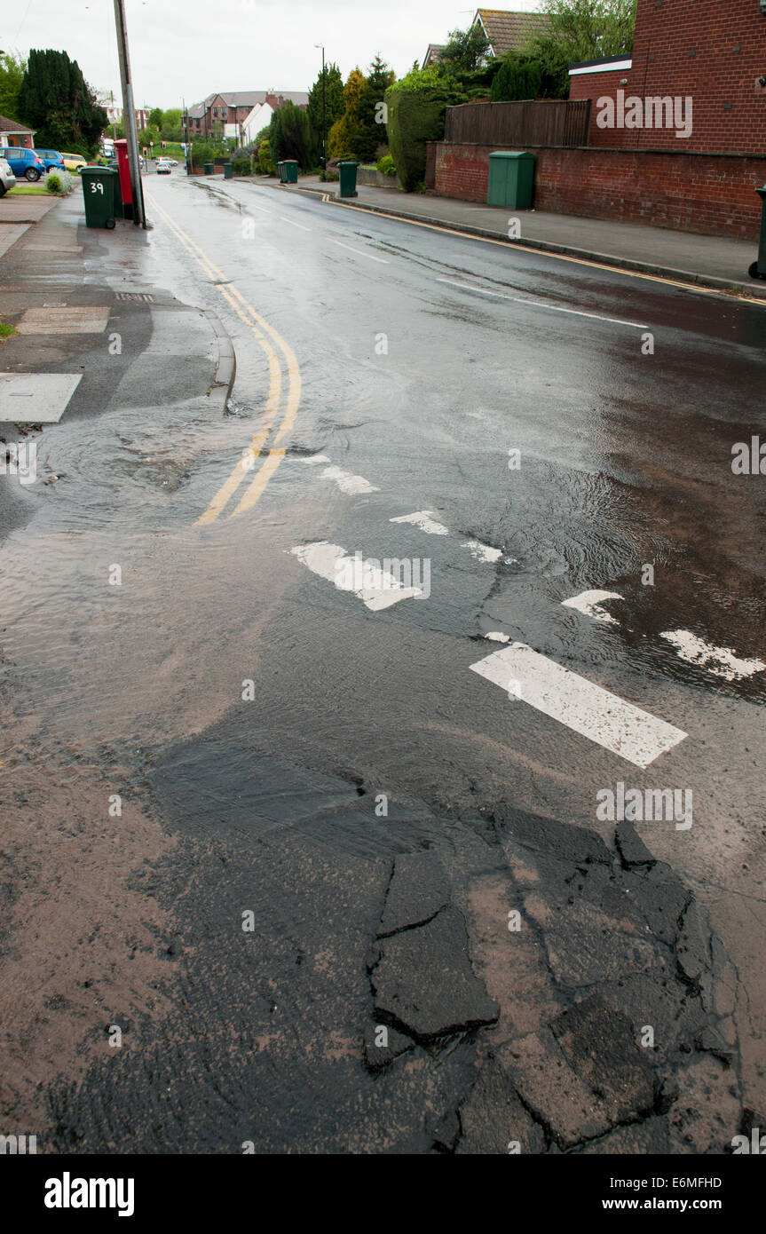 Fuite d'eau d'une rafale d'eau principale dans la route Banque D'Images