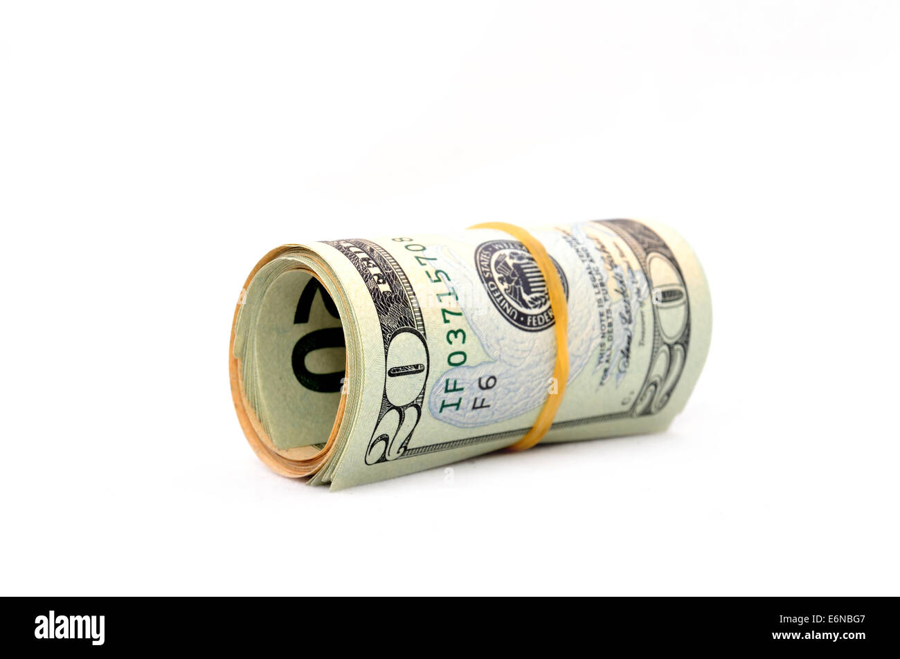 Rouleau de 20 dollar bills sur fond blanc. Isolated on white Banque D'Images