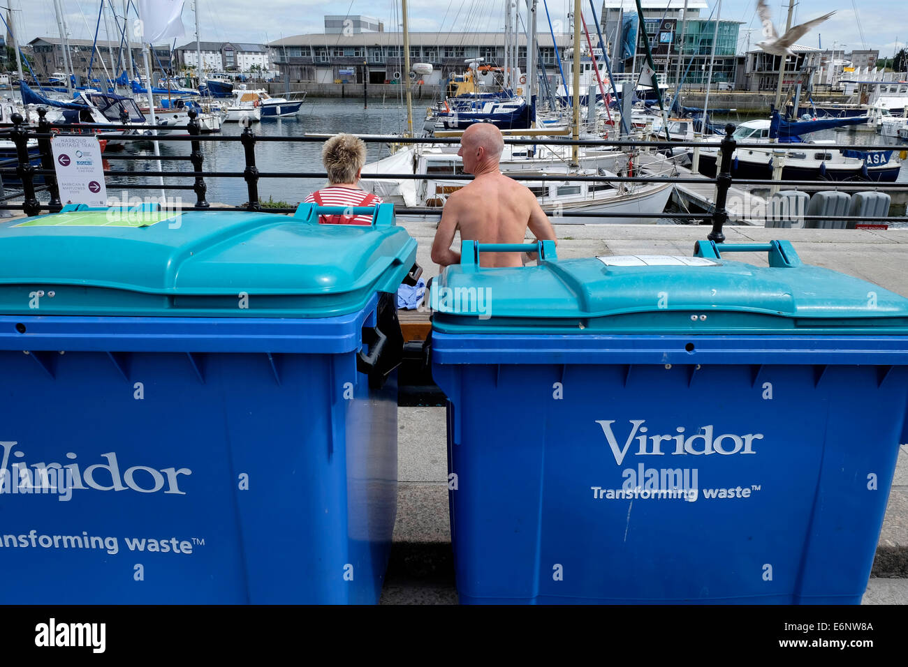 Viridor poubelles et les gens assis sur un banc, Barbican, Plymouth, Devon, England, UK Banque D'Images