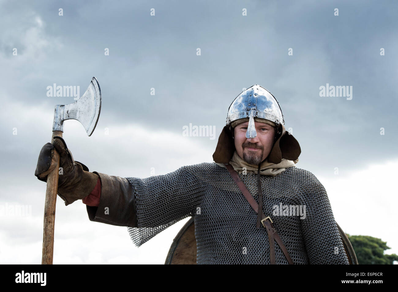 Port Viking armor et transportant une hache à une reconstitution historique. UK Banque D'Images