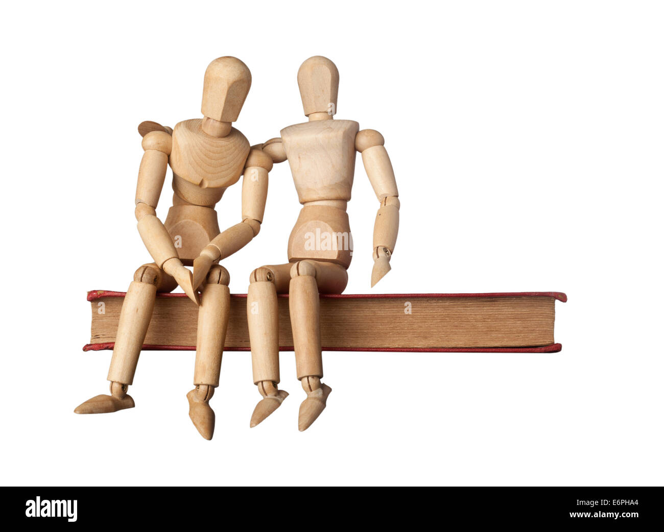 Consolation d'un(e) ami(e) représenté par deux figurines sur un livre isolé sur fond blanc Banque D'Images