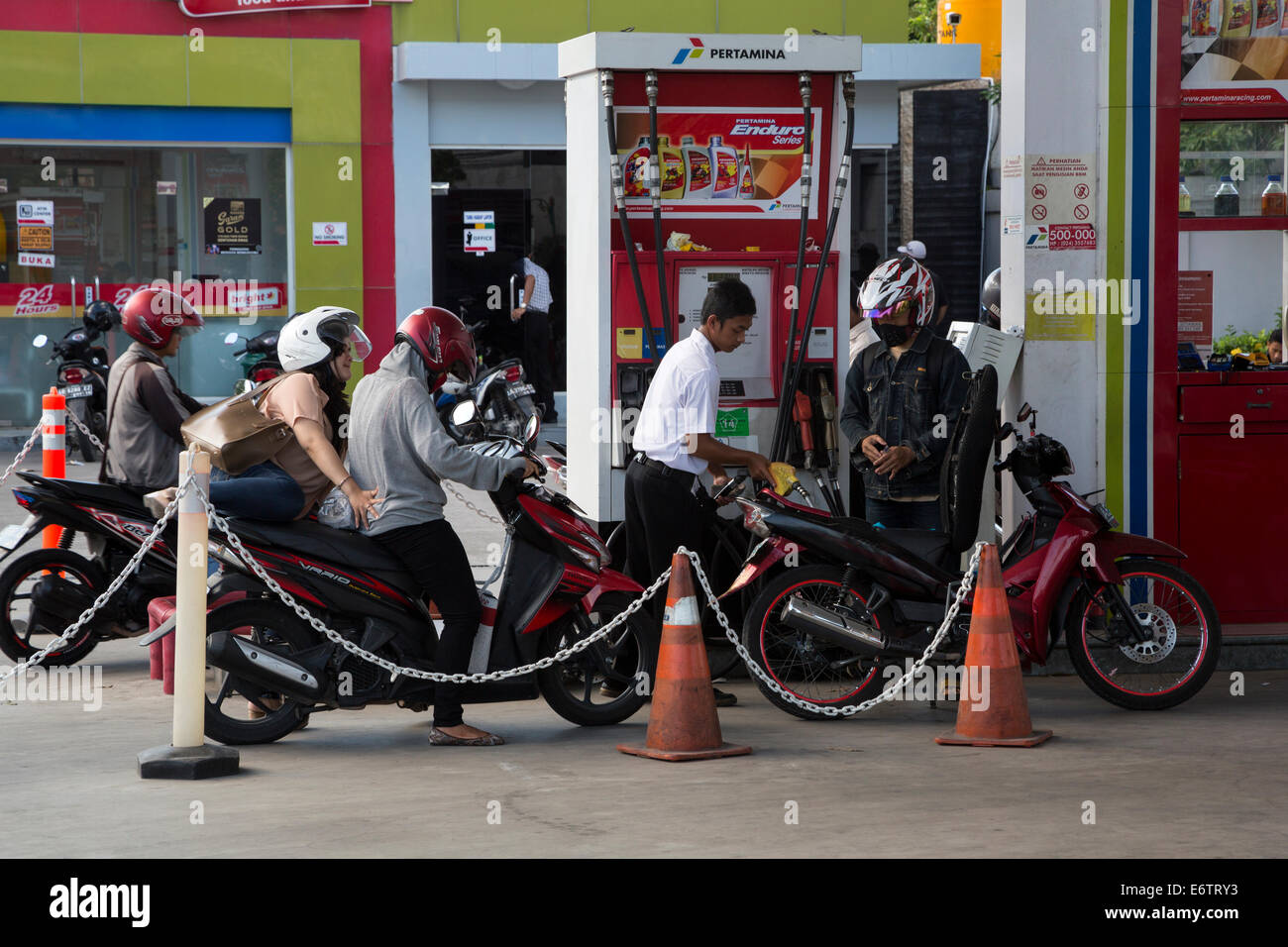 Yogyakarta, Java, Indonésie. Les motos de l'alignement pour carburant en station service. Banque D'Images