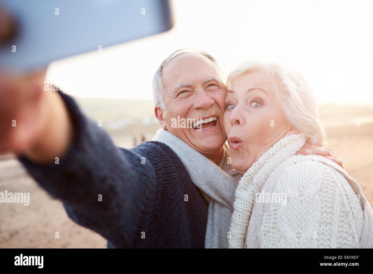 Senior Couple Standing On Beach Prendre Selfies Banque D'Images Senior Couple Standing On Beach Prendre Selfies Banque D'Images
