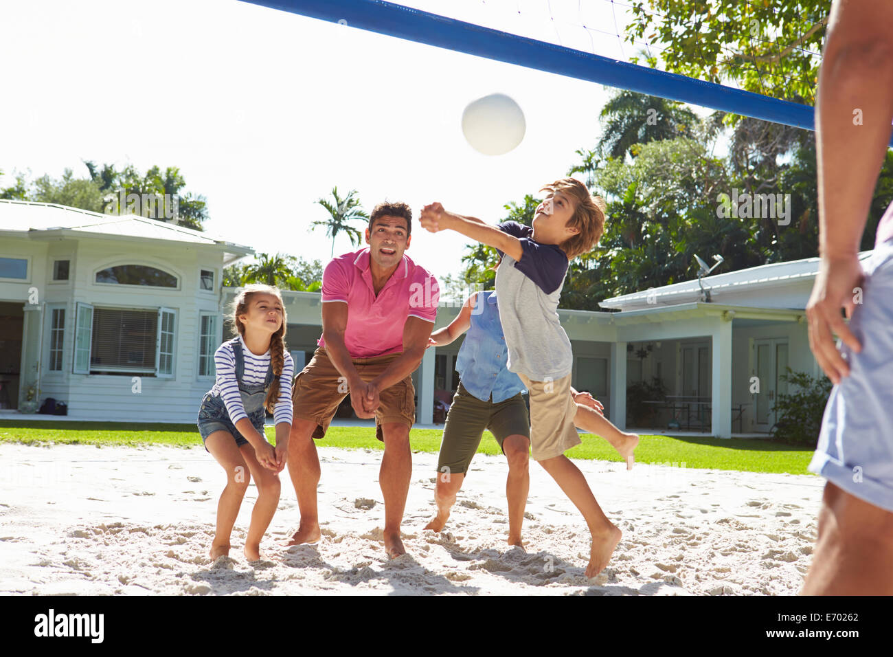 Famille jouer au volley-ball dans le jardin à la maison Banque D'Images