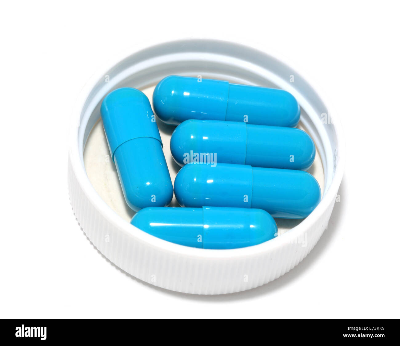 Pilules bleues et la garniture sur un fond blanc Banque D'Images