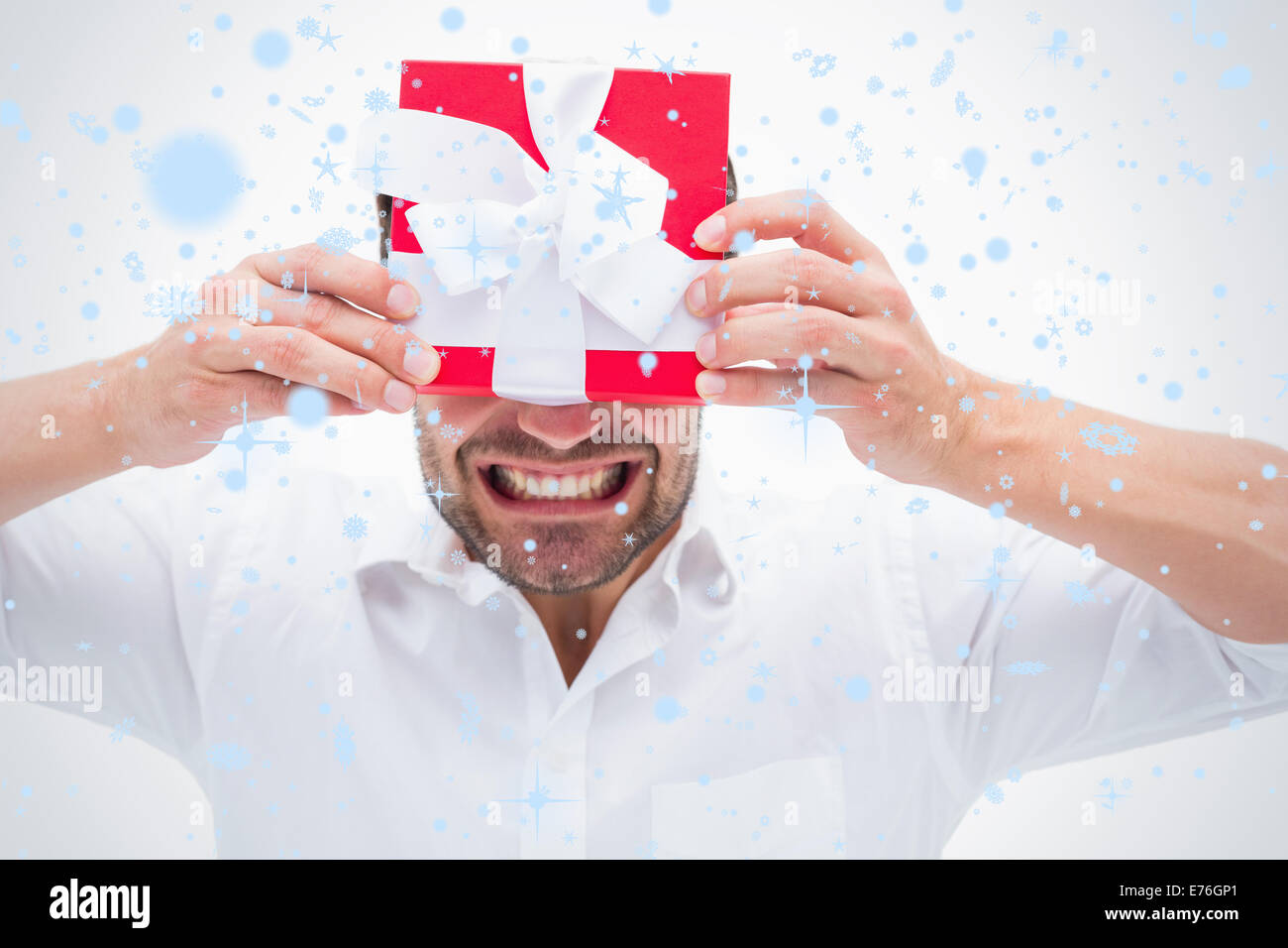 Composite image of man holding a present Banque D'Images