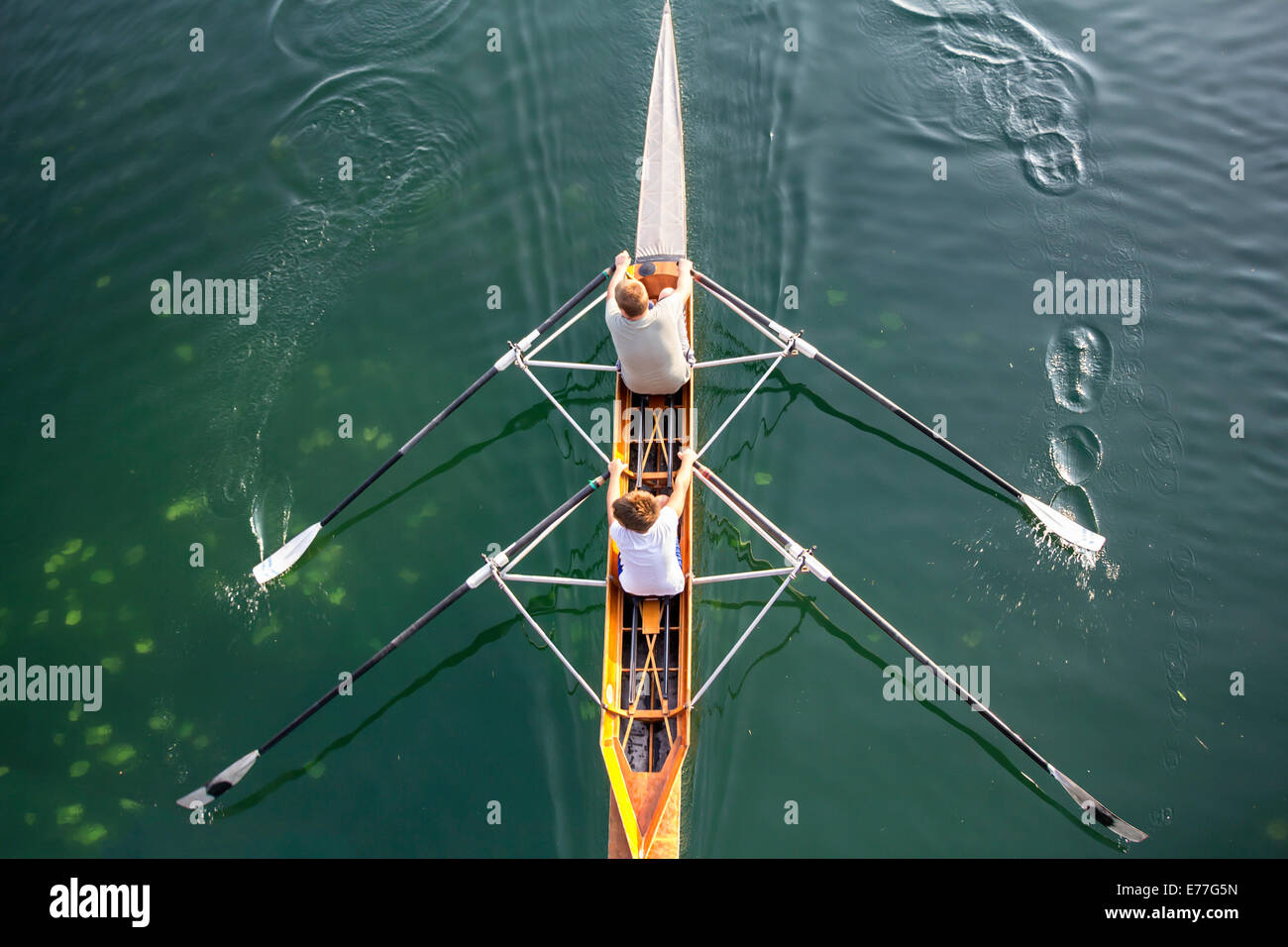 Deux jeunes garçons dans un bateau, les palettes sur le paisible lac Banque D'Images