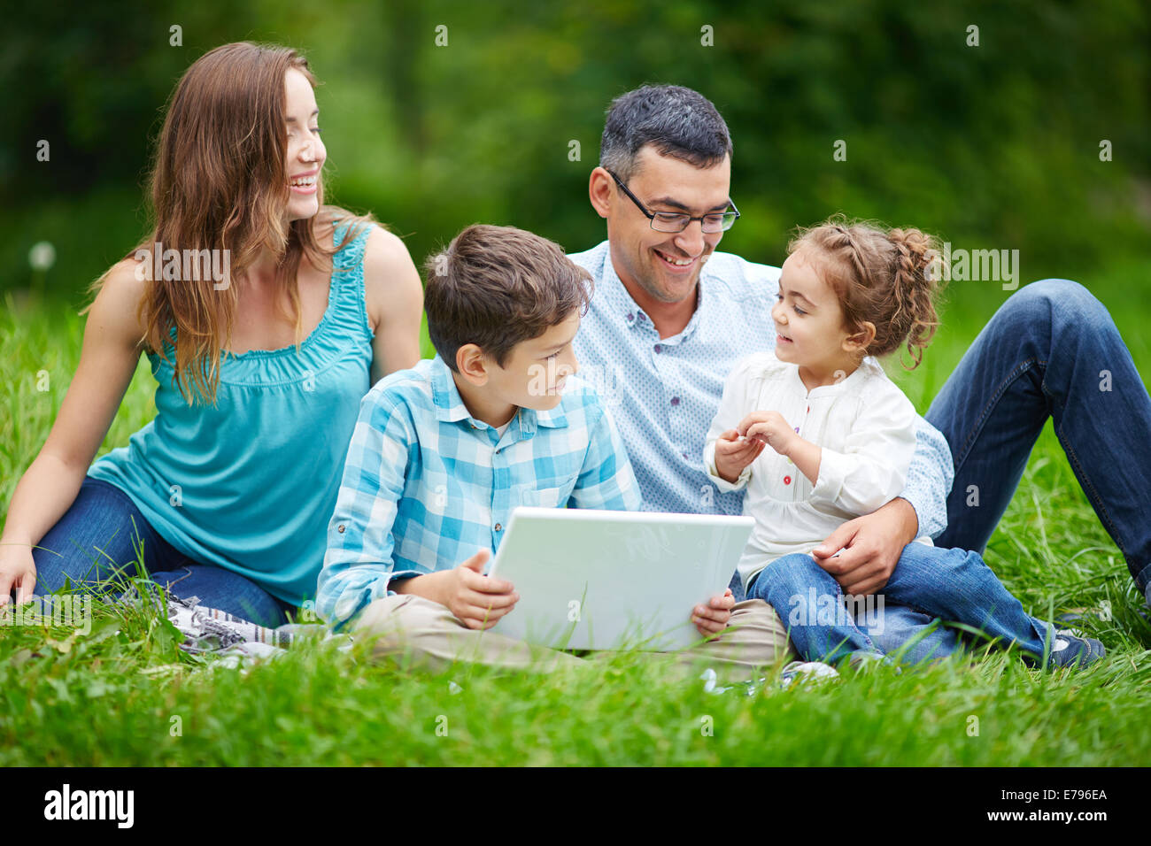 Couple heureux de passer du temps dans le parc avec leurs enfants Banque D'Images