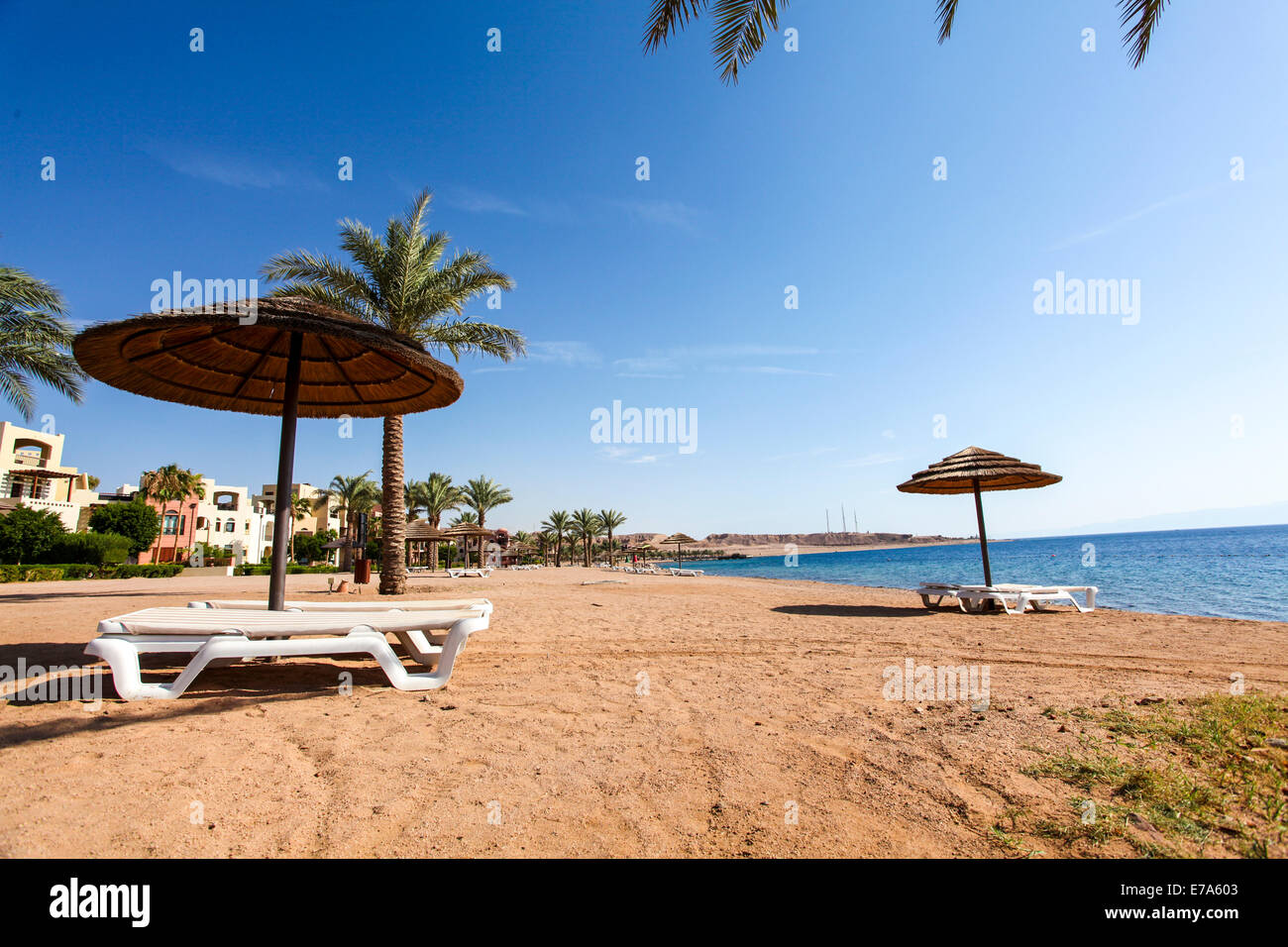 La Jordanie, Aqaba, Tala Bay plage avec un parasol et lits de soleil Banque D'Images