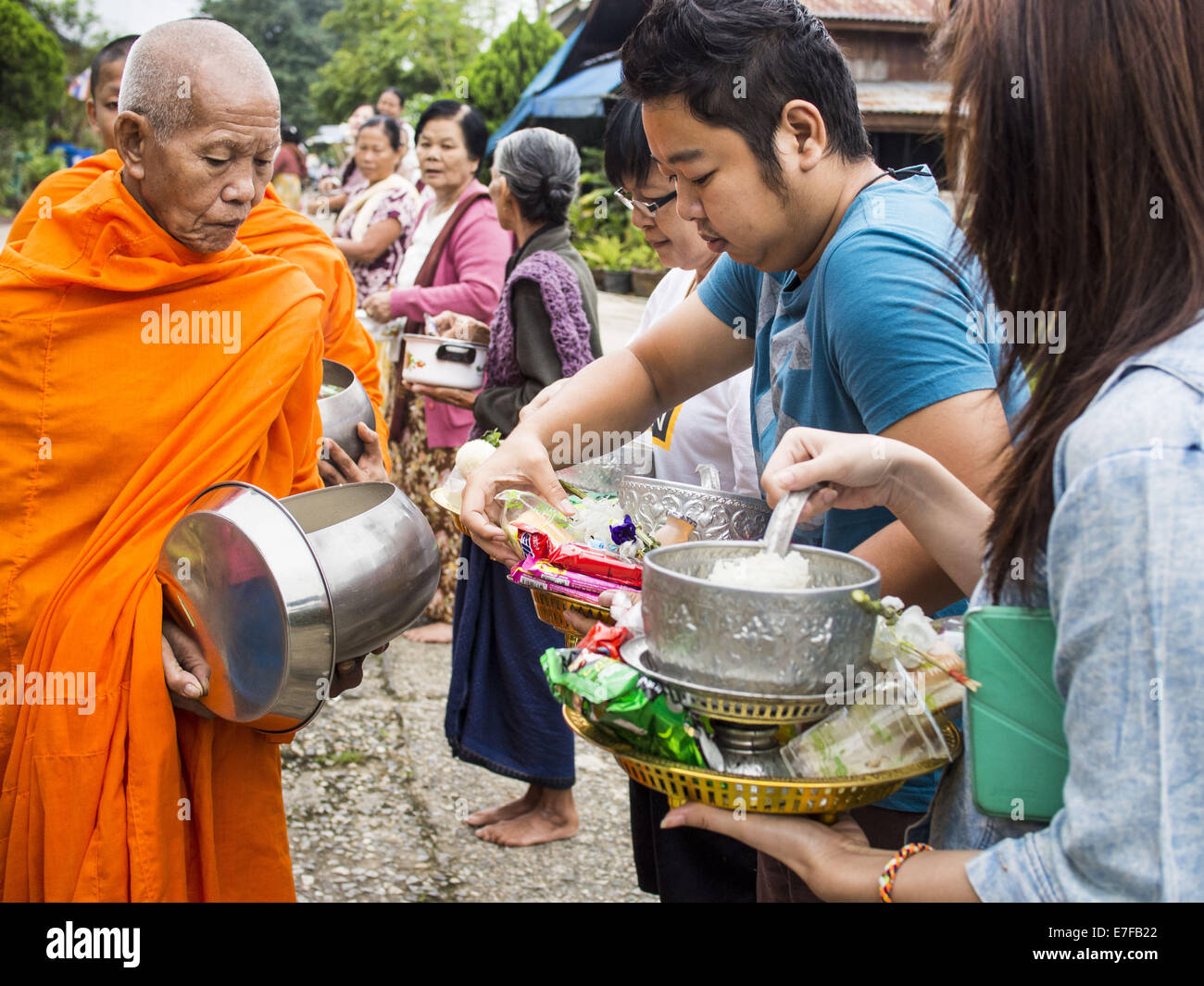 Sangkhla Buri, Kanchanaburi, Thaïlande. 16 Sep, 2014. Les gens présents d'aliments et d'autres offrandes à lun des moines bouddhistes à leurs tours dans la matinée l'aumône à Sangkhla Buri communauté lun. Les LUN sont certaines des premières personnes à s'installer dans le sud-est asiatique, et étaient responsables de la propagation du Bouddhisme Theravada en Thaïlande et en Indochine. La Mon pays est dans le sud-ouest de la Thaïlande et le sud-est du Myanmar (Birmanie). Credit : ZUMA Press, Inc./Alamy Live News Banque D'Images