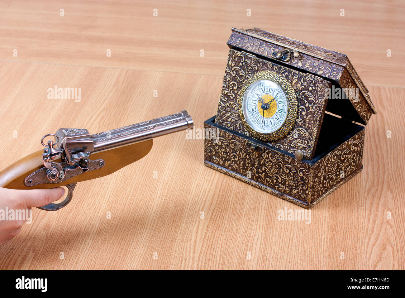 Vieille horloge avec une personne tenant un pistolet. Souligné par le temps Banque D'Images