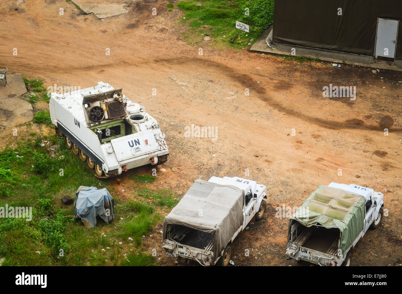 Véhicules et d'un hangar un camp à Monrovia, Libéria, vu du haut des ruines de l'Hôtel Africa Banque D'Images