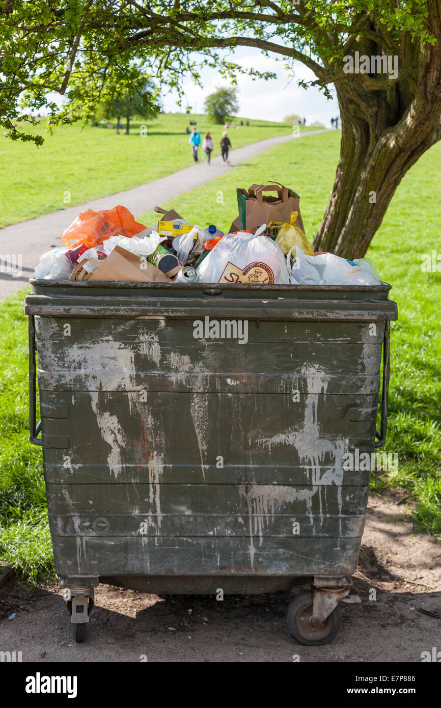 Grande poubelle à roulettes ou poubelle pleine de détritus dans un parc, London, England, UK Banque D'Images
