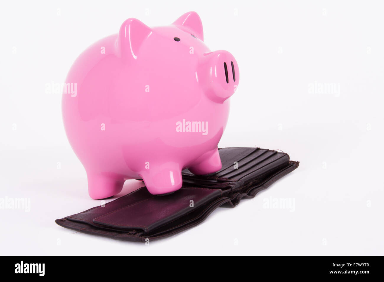 Faim pink piggy bank en attente de l'argent sur dark wallet, isolé sur fond blanc. Banque D'Images