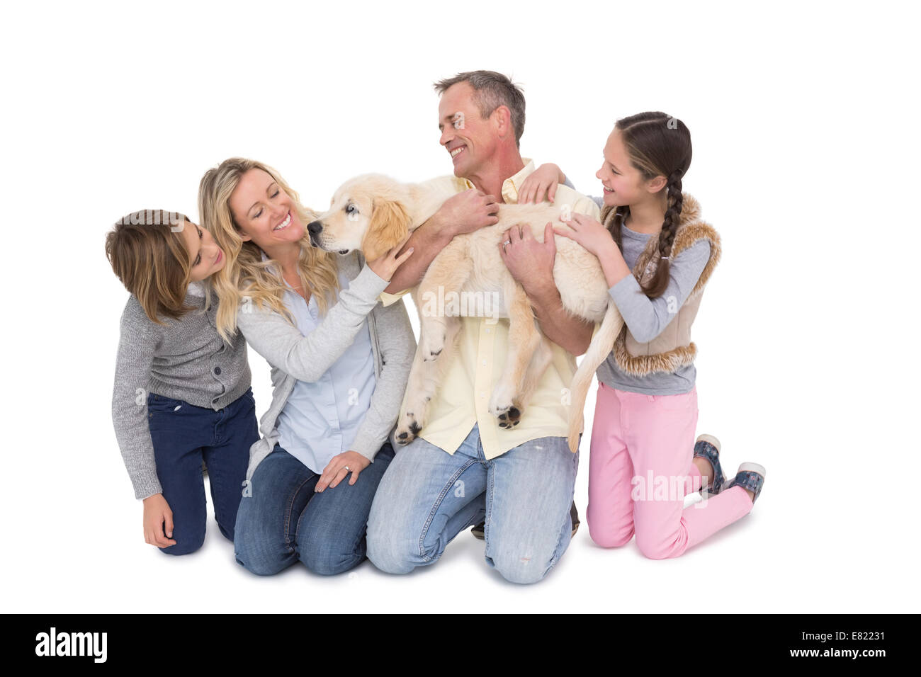 Famille avec leur chien posing and smiling at camera ensemble Banque D'Images