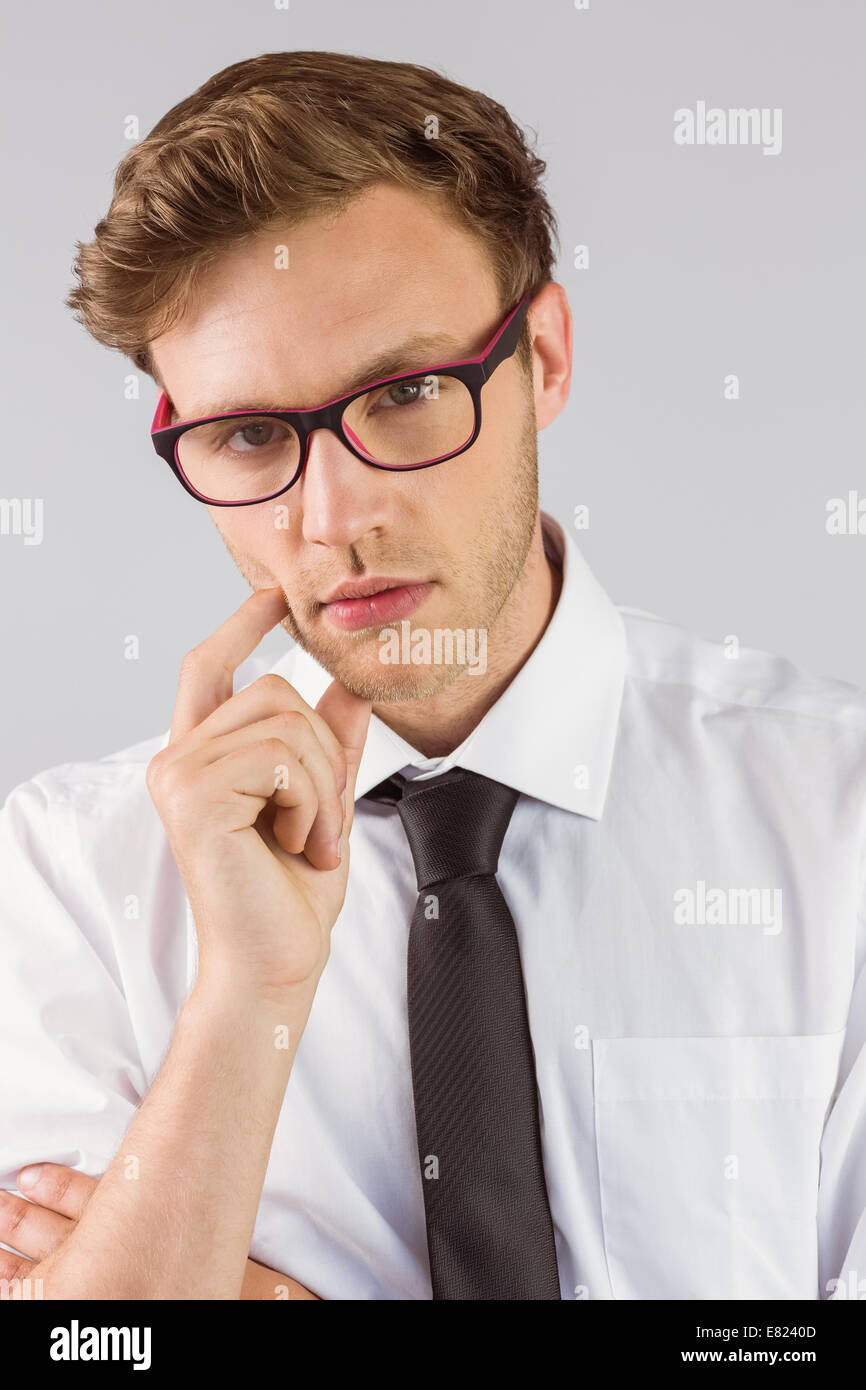 Young businessman thinking looking at camera Banque D'Images