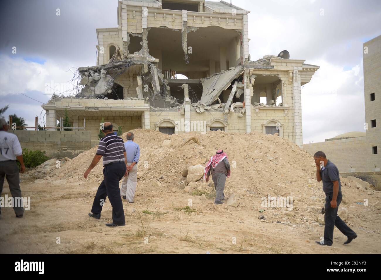 Bethléem, Proche-Orient. Sep 29, 2014. Palestiniens inspecter les décombres d'une maison après qu'il a été en partie démoli par les bulldozers israéliens à Abu Dis, ville située près de la ville cisjordanienne de Bethléem le 29 septembre, 2014. Credit : Emad Drimly/Xinhua/Alamy Live News Banque D'Images