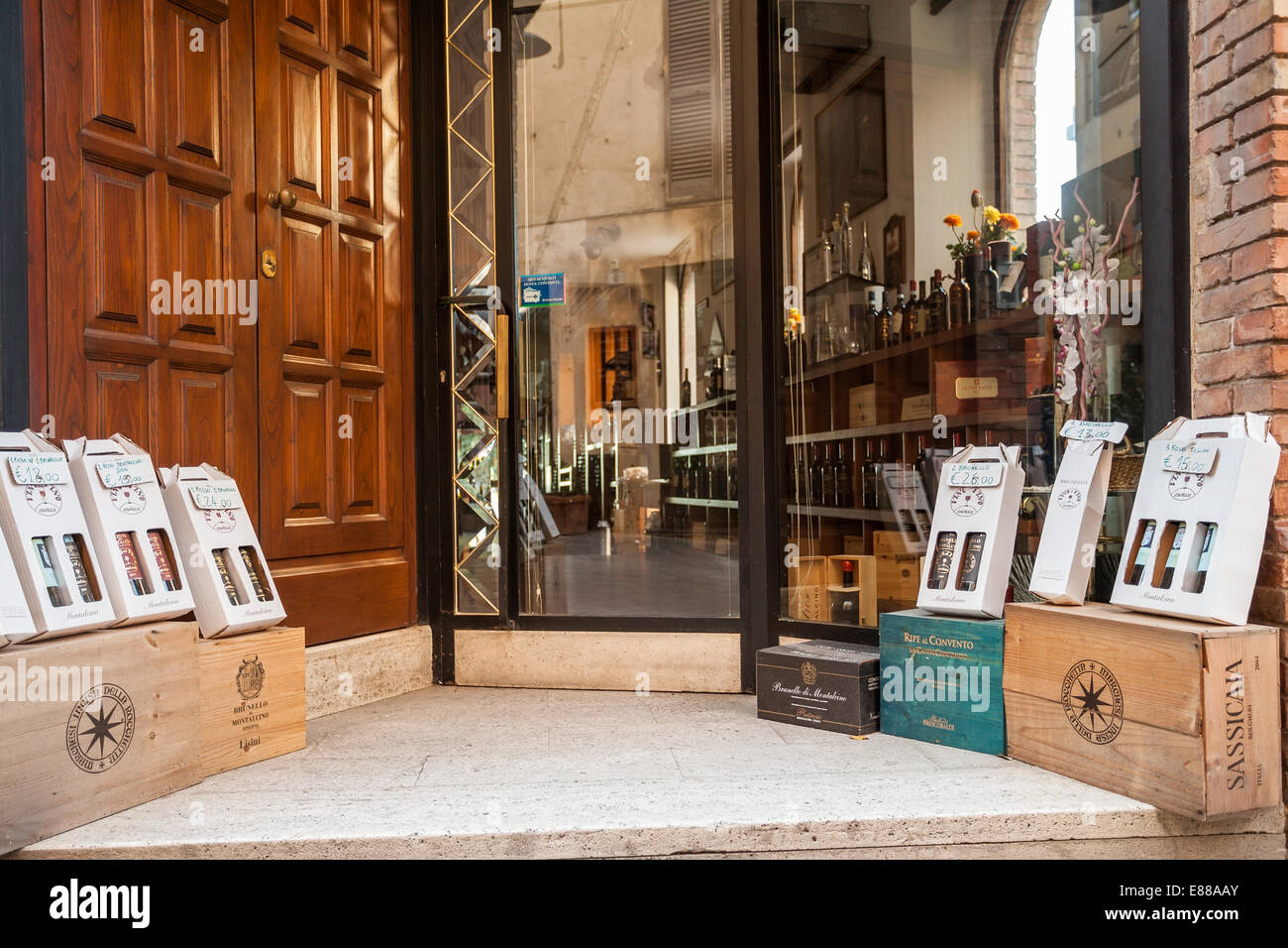 Des bouteilles de vin Brunello sur les caisses en bois affiche avec : en face d'un magasin de vin à Montalcino Italie Toscane Banque D'Images