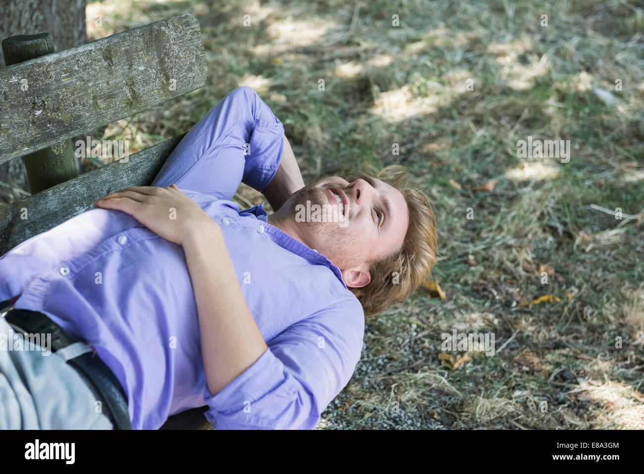 Mid adult man relaxing on bench Banque D'Images