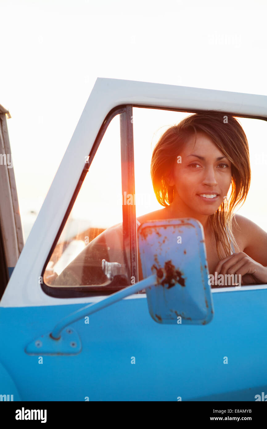 Portrait of young female surfer par pick up truck fenêtre, Leucadia, California, USA Banque D'Images