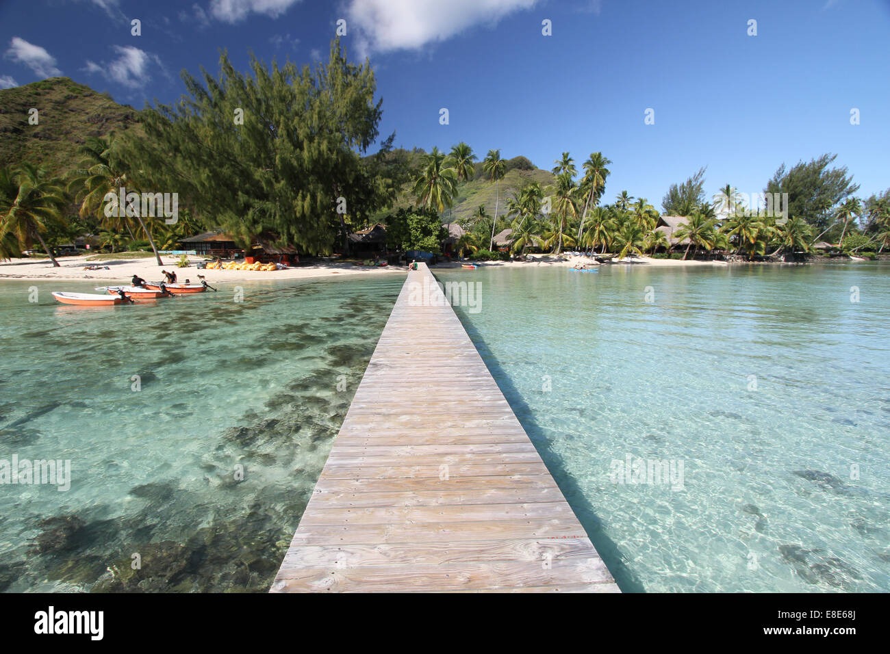 Les petits bateaux amarrés près d'une jetée dans un lagon tropical à proximité d'une plage de sable blanc Banque D'Images