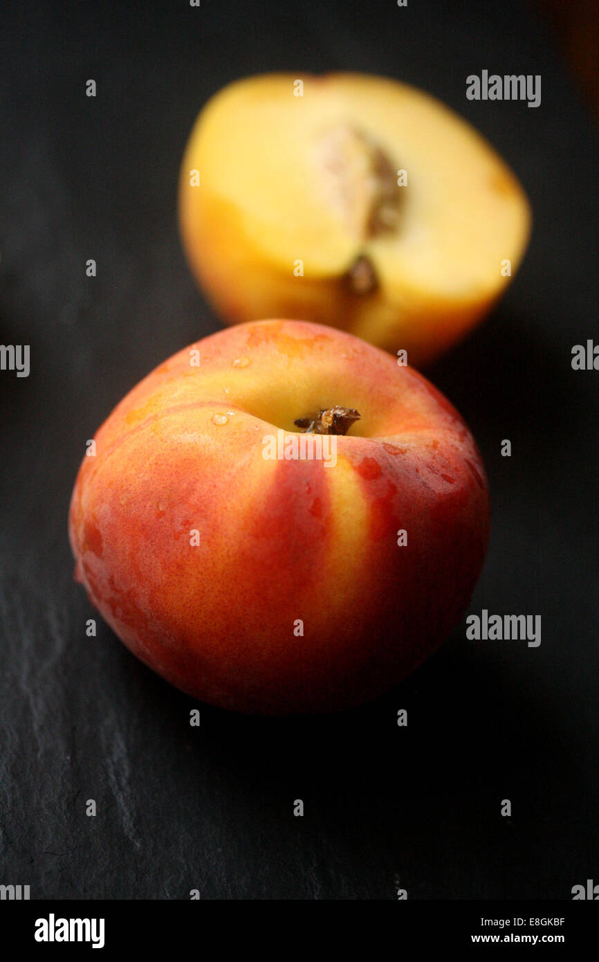 Fresh peach peach et coupées en deux Banque D'Images