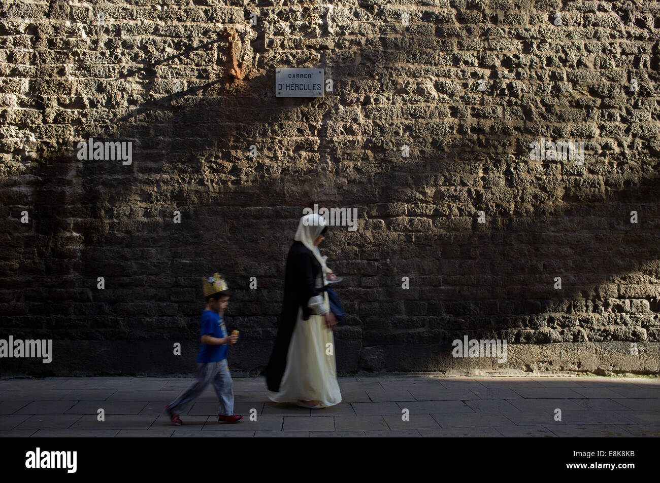 Dans le quartier gothique de Barcelone et une femme ​​a la marche de l'enfant par la rue. Banque D'Images