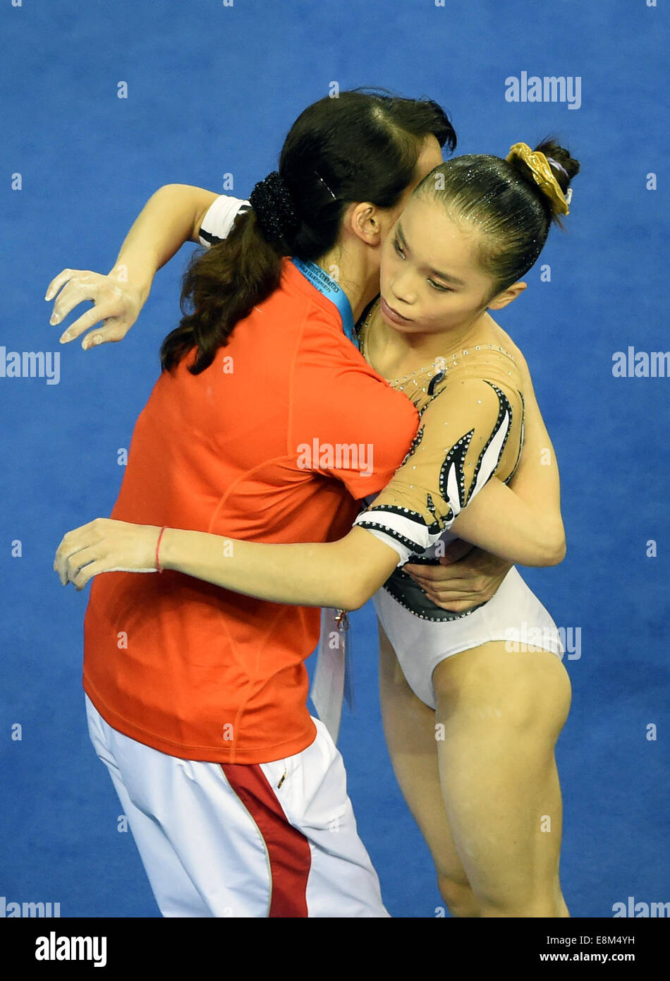 Nanning, Chine, région autonome Zhuang du Guangxi. 10 Oct, 2014. Le gymnaste chinois Yao Jinnan hugs son entraîneur après la féministe tout autour de la 45e finale des Championnats du monde de gymnastique à Nanning, capitale de la Chine du Sud, région autonome Zhuang du Guangxi, le 10 octobre 2014. Yao Jinnan classée cinquième dans la finale. (Xinhua/Huang Xiaobang) (djj) Banque D'Images