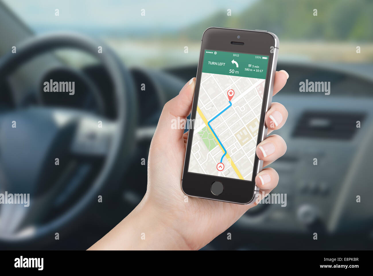 La pilote assis dans la voiture et la tenue black téléphone intelligent avec la carte de l'application de navigation GPS avec itinéraire sur Banque D'Images