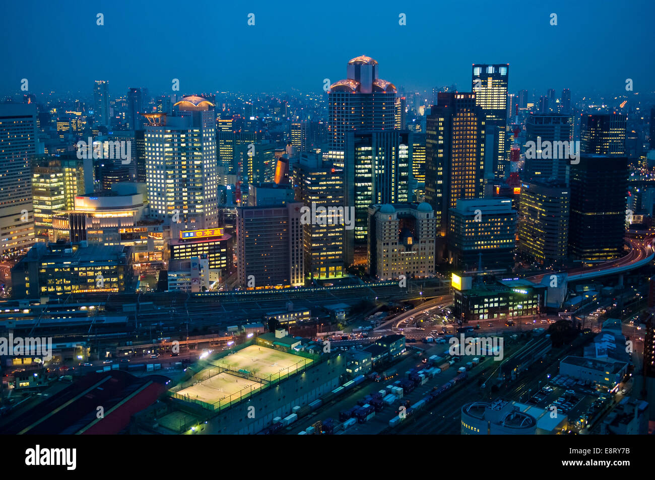L'heure bleue dans la ville japonaise d'Osaka vu de haut. Les lumières de la ville brillent dans la lumière du soir Banque D'Images
