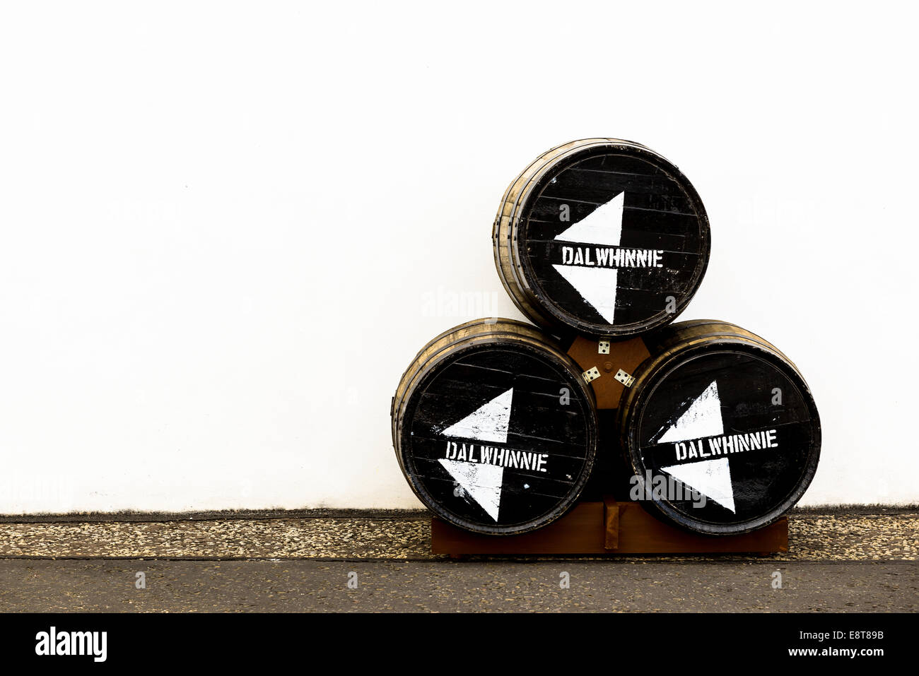 Trois barils à la distillerie de whisky Dalwhinnie, Highland, en Écosse, contre un mur à l'arrière-plan blanc. Whiskey. Pile de barils Banque D'Images
