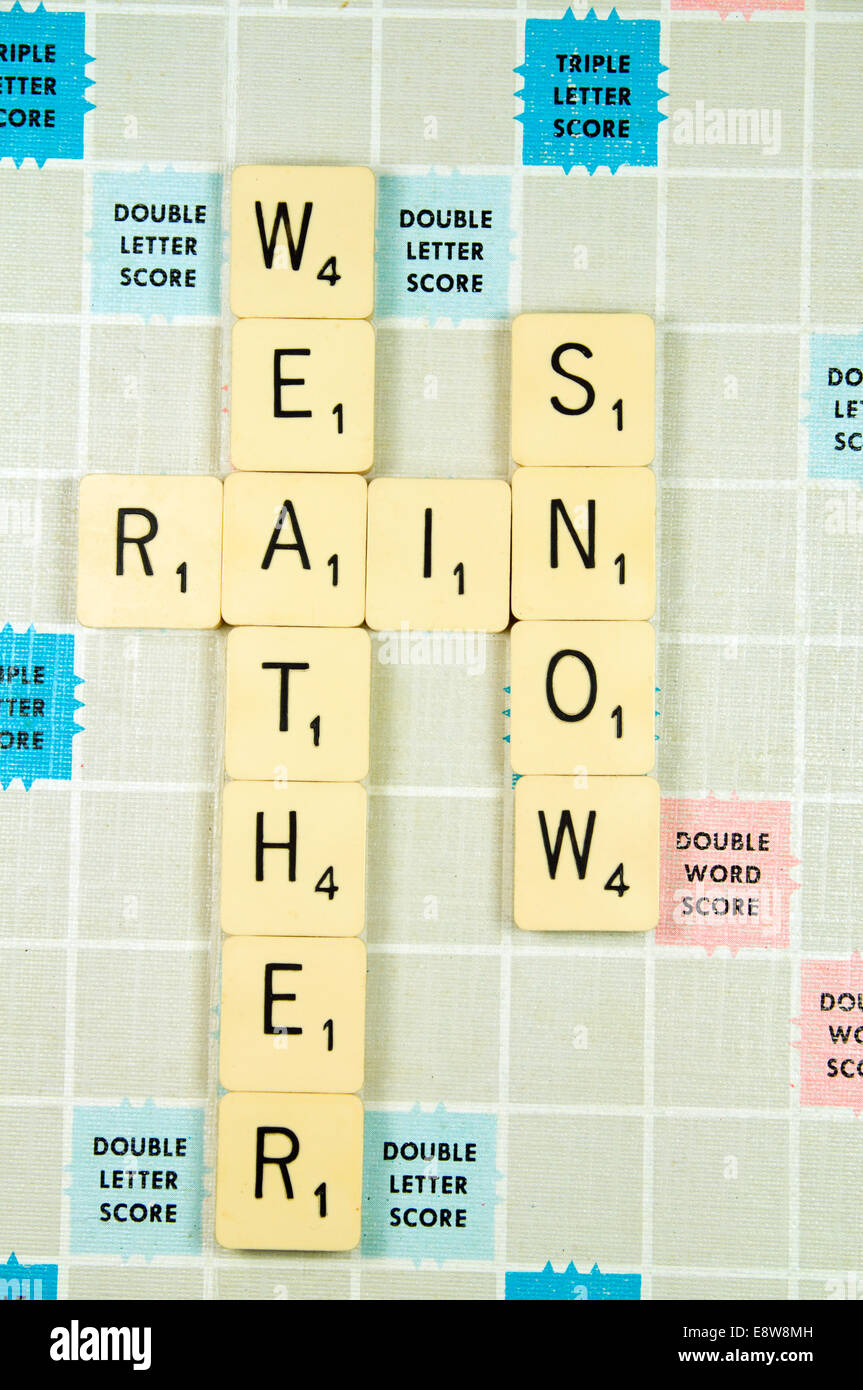 Neige pluie météo précisées sur le Scrabble board. Banque D'Images