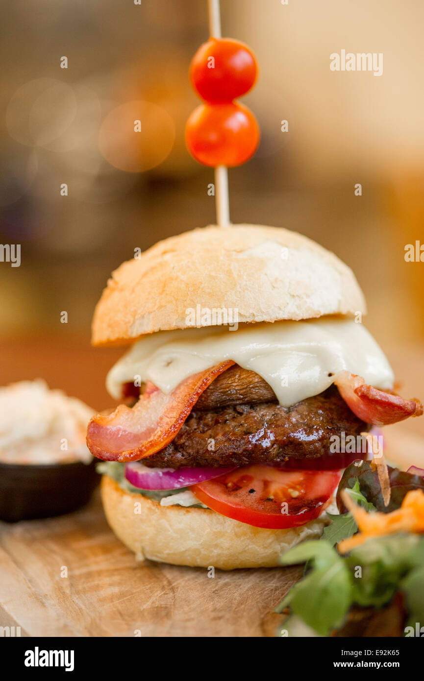 Beefburger gastronomique avec toutes les garnitures et accompagnements Banque D'Images