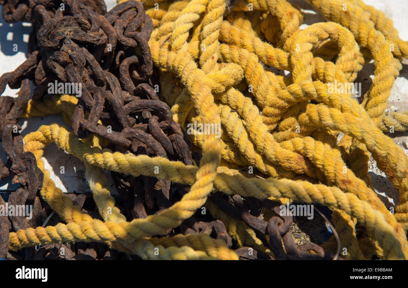 Corde jaune et chaîne rouillée à l'Harbour à Milos, Grèce Banque D'Images