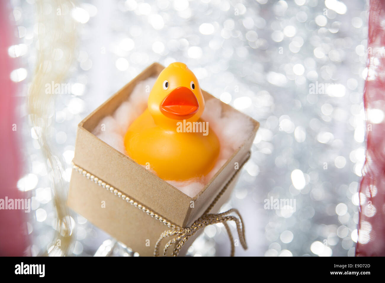 Boîte cadeau de Noël ouvert avec canard en caoutchouc, le ruban et l'arc Banque D'Images