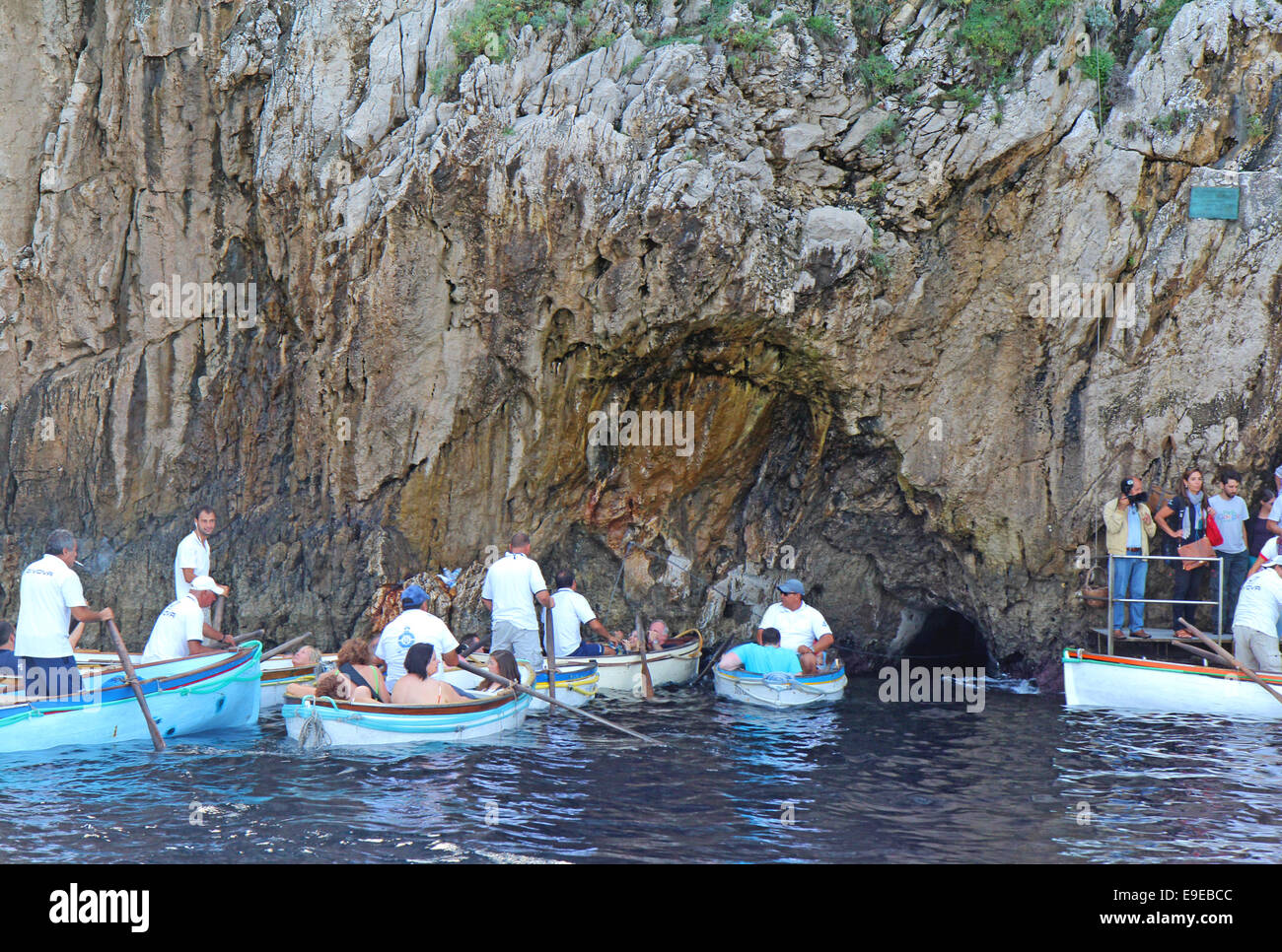 Les touristes en ligne et dans de petites embarcations attendent d'entrer dans la célèbre Grotte bleue sur l'île de Capri, Italie Banque D'Images