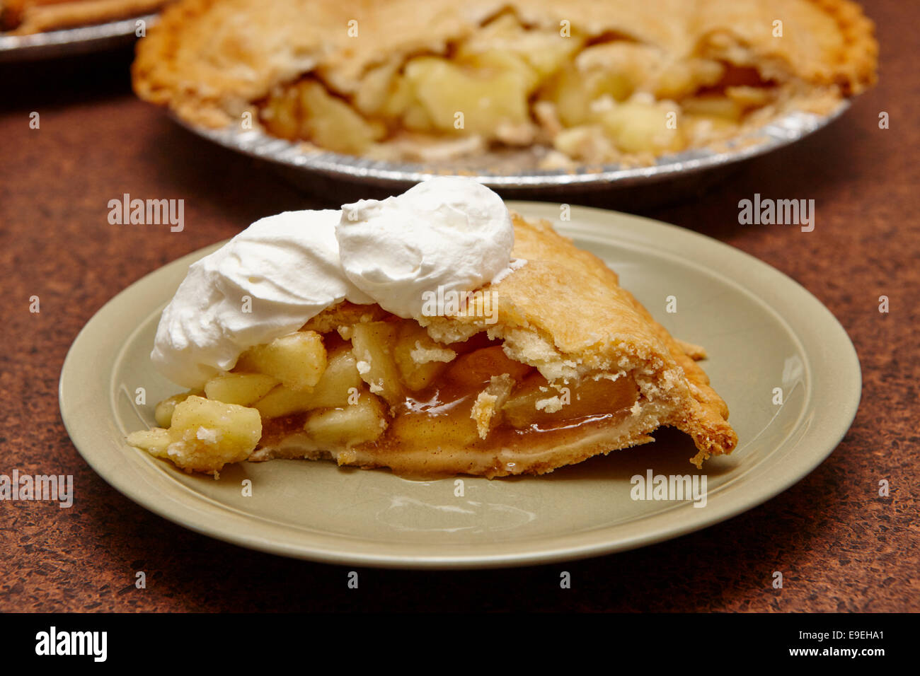 Grande partie de la production en masse de la tarte aux pommes avec crème fouettée topping Banque D'Images