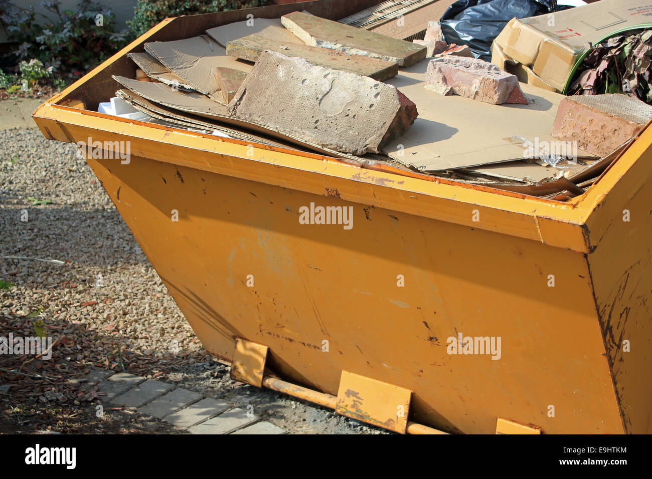Close-up of yellow passer plein de béton et d'ordures symbolisant la construction, rénovations et déchets environnementaux Banque D'Images